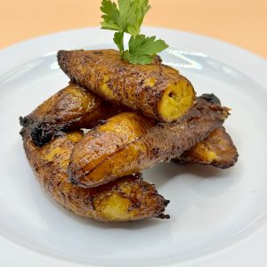 Grilled plantains with garnish on white plate Baytown TX